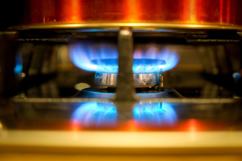 blue colored flame on a gas stove burner